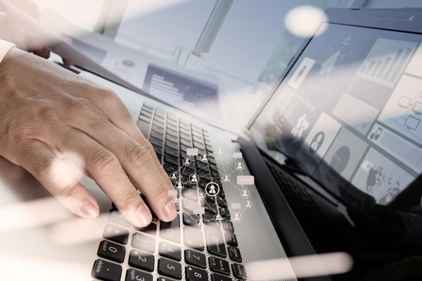 Double exposure of businessman hand working with new modern computer and business strategy as concept